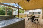 back porch with hot tub and seating